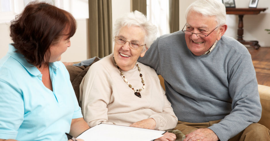 elderly-couple-with-caregiver-in-blue-top