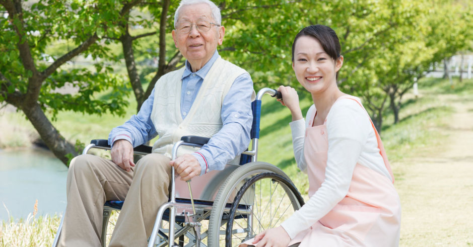 asian-elderly-in-wheelchair-with-caregiver